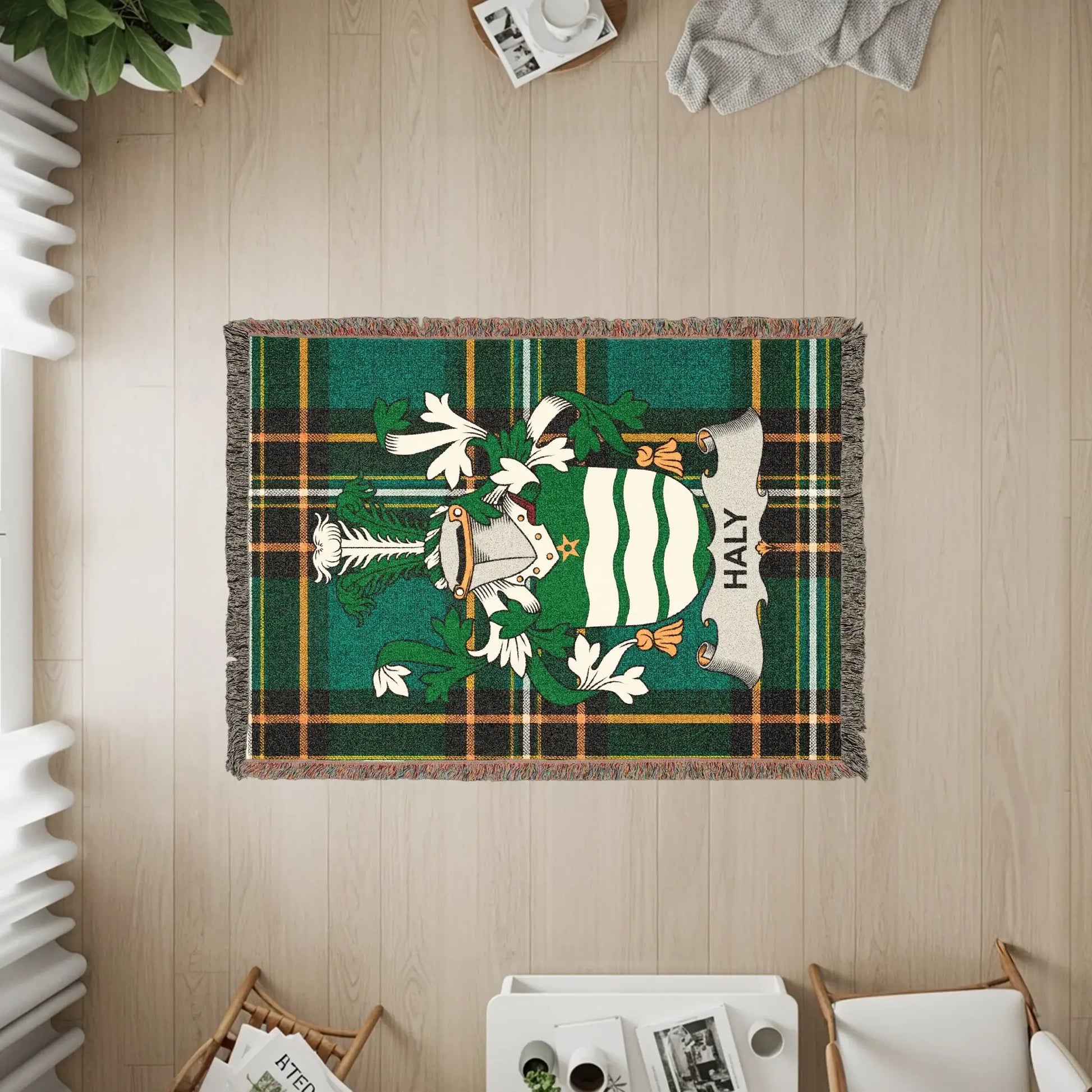 Haly family crest on a green tartan blanket with fringe.