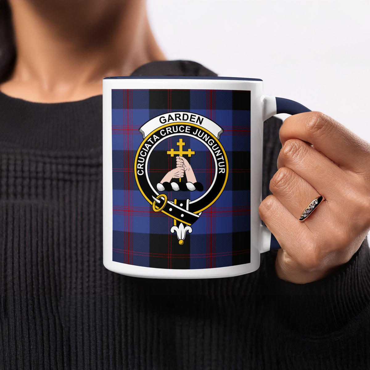 Close-up lifestyle view of Garden Scottish family crest artwork on a navy 11 oz accent mug with a tartan background