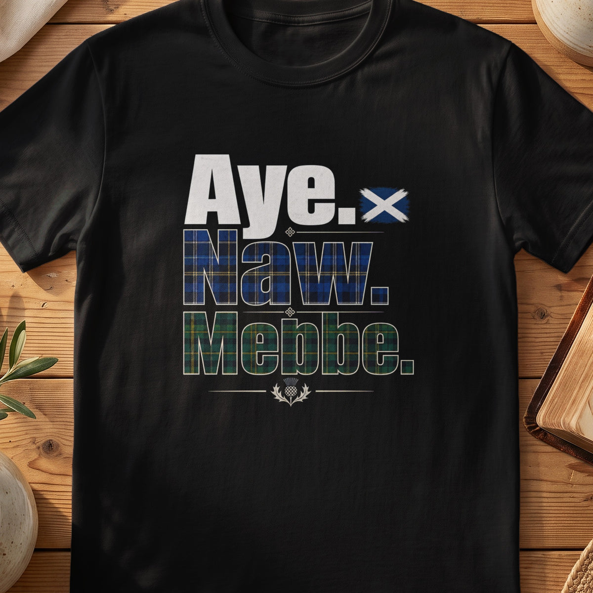 Black Gildan 64000 unisex T-shirt flatlay with Aye Naw Mebbe Scottish graphic design