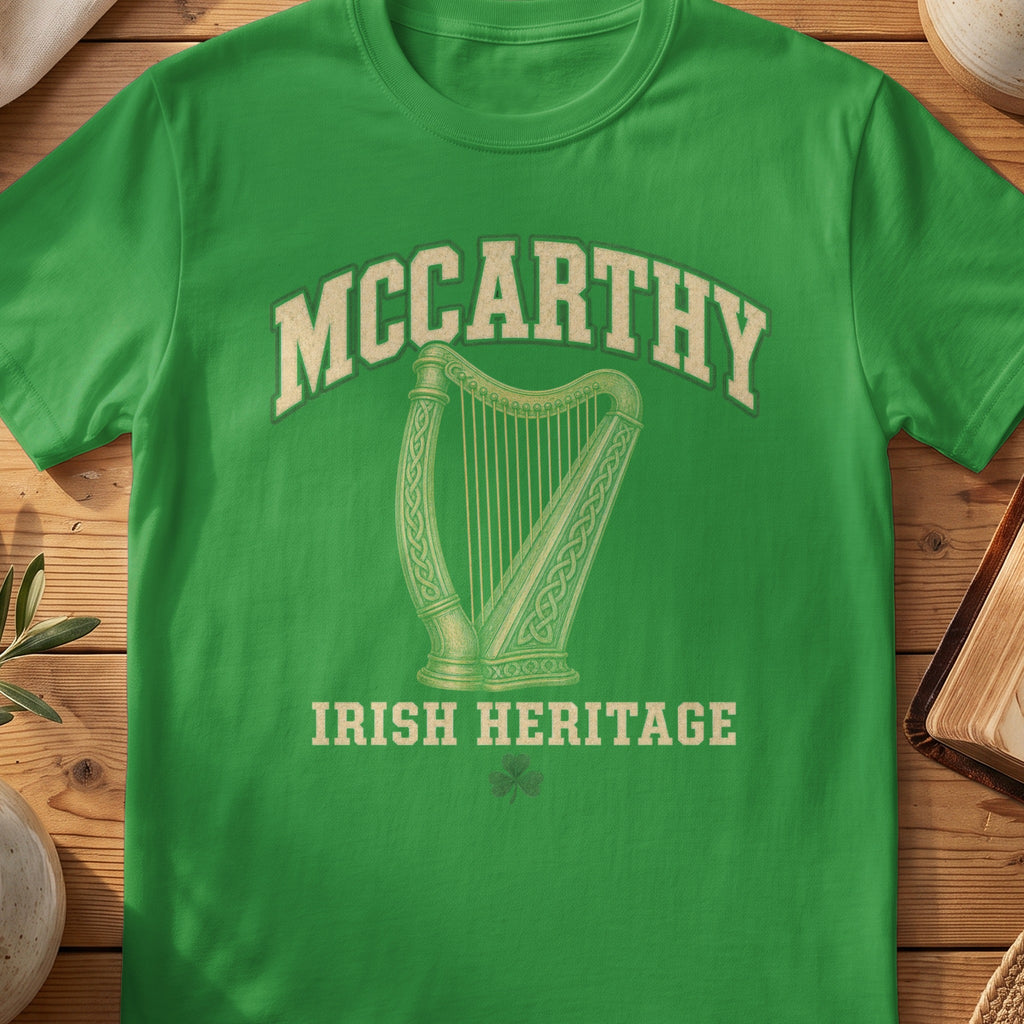 McCarthy Irish harp T-shirt in Irish Green, with cream surname lettering, a gold-toned harp, green shamrock and “Irish Heritage” text.