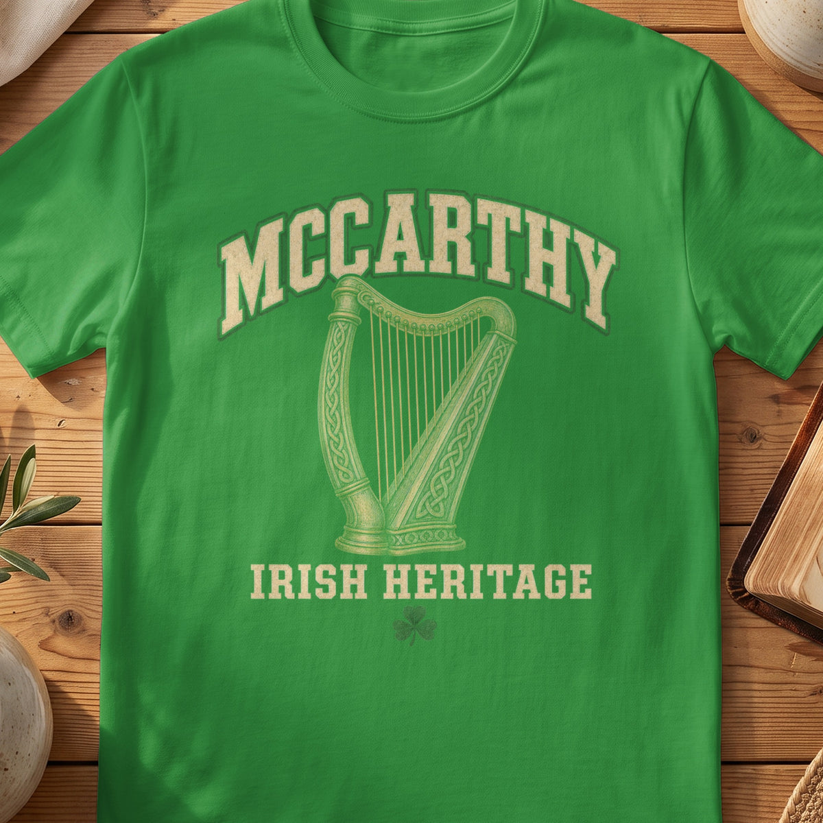 McCarthy Irish harp T-shirt in Irish Green, with cream surname lettering, a gold-toned harp, green shamrock and “Irish Heritage” text.