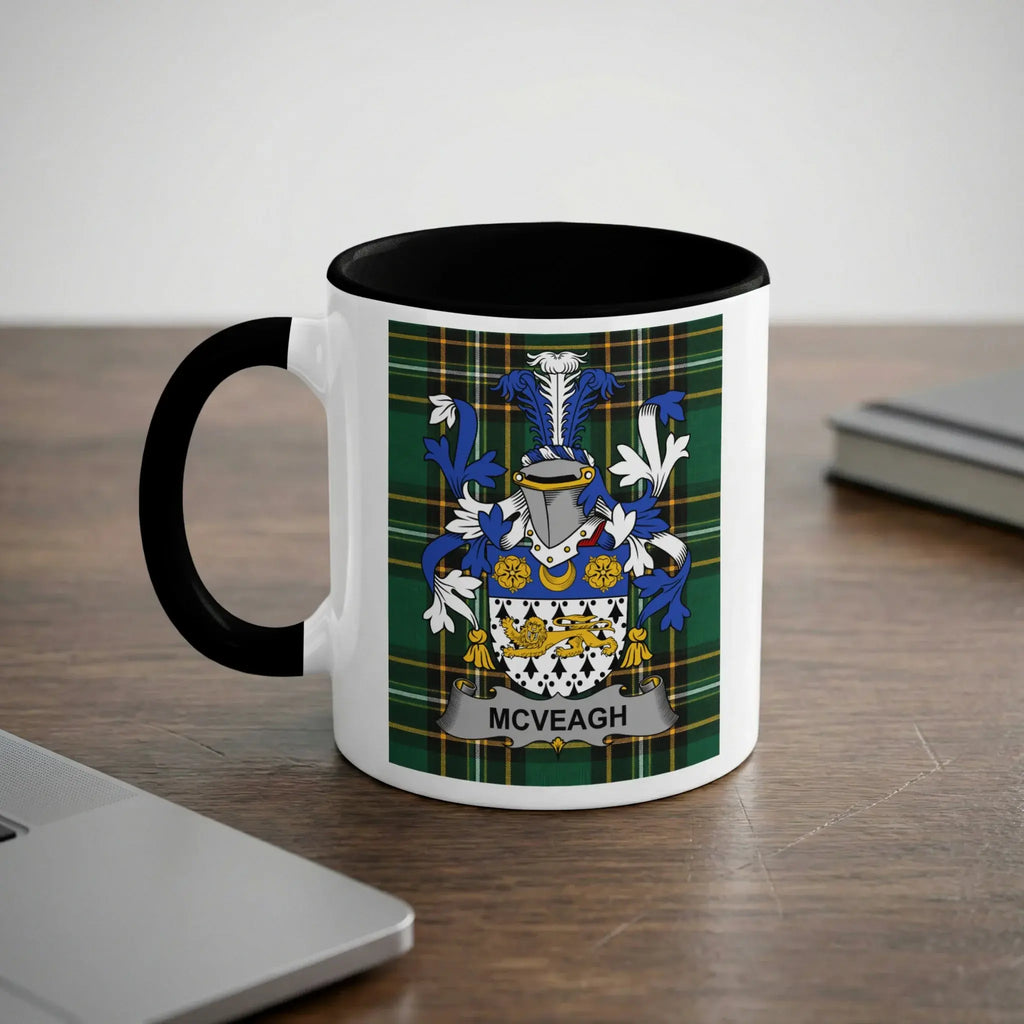 White mug with black handle featuring a family crest with "McVEAGH" text.