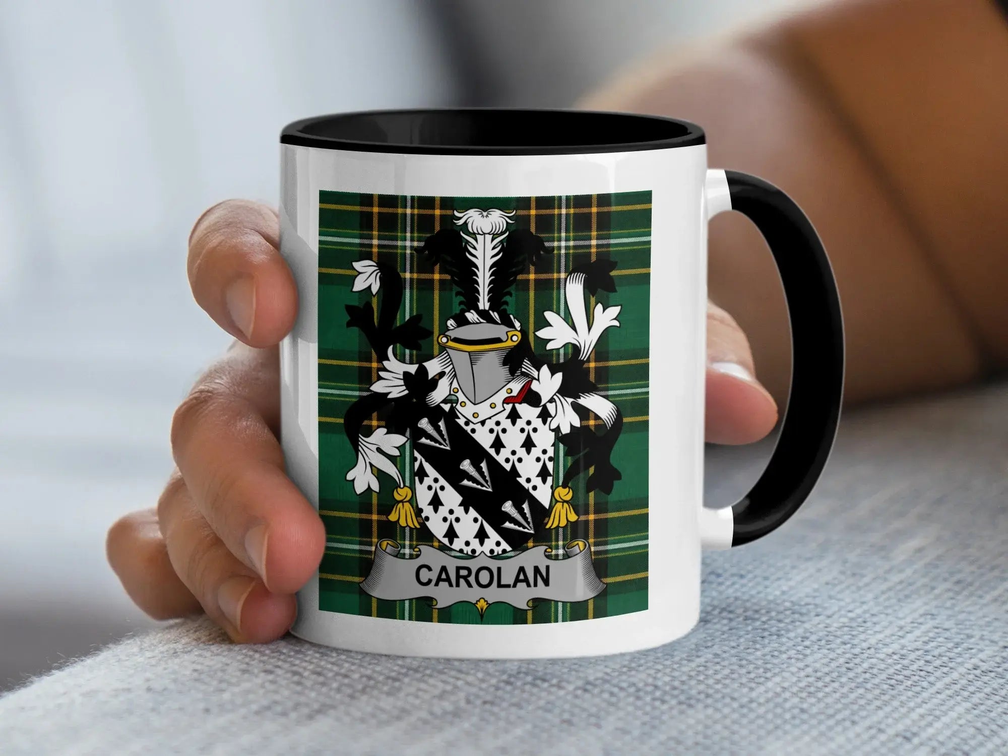 White mug with black handle featuring green plaid and the CAROLAN family crest.