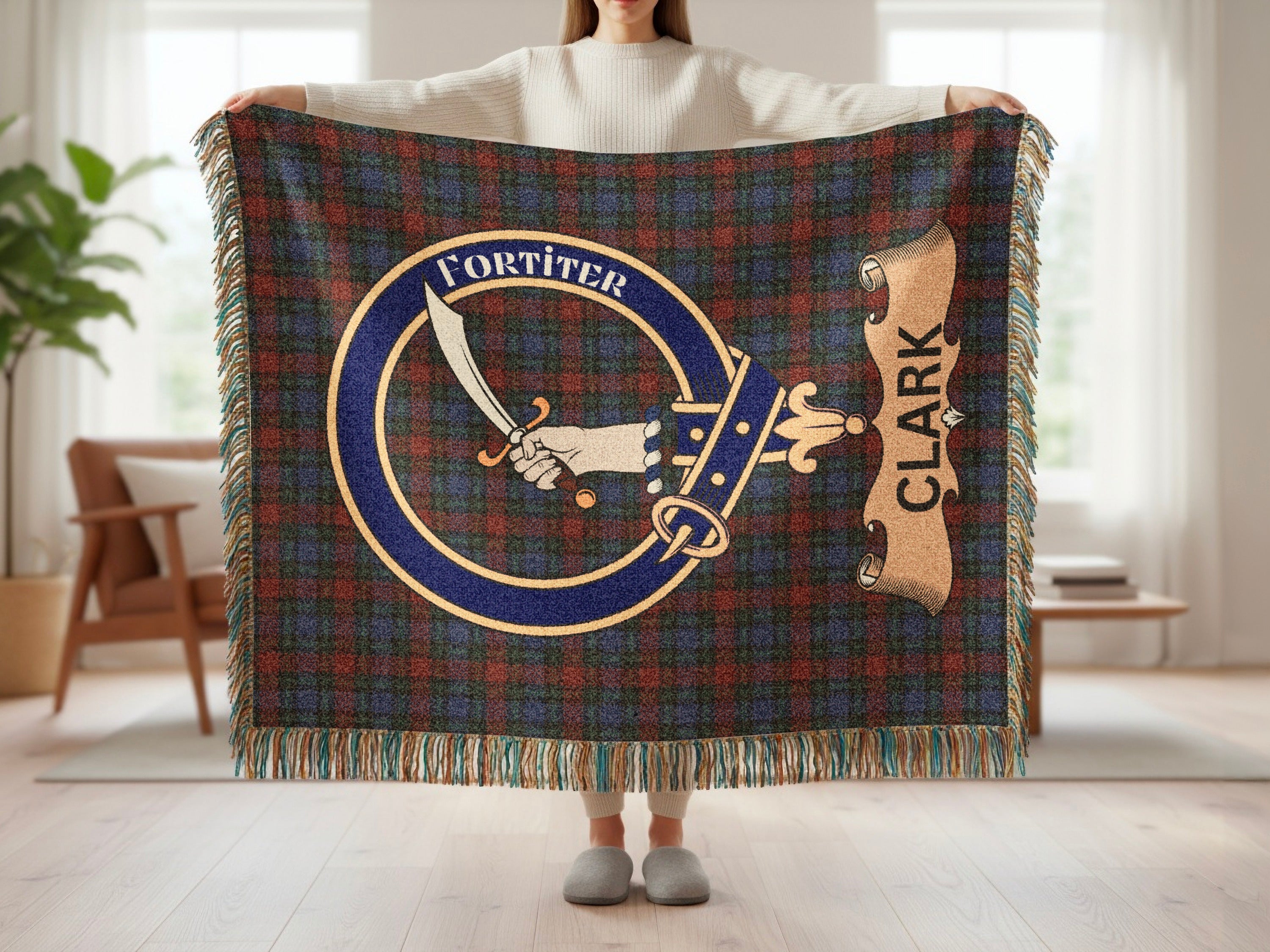Clark crest with sword and Fortiter motto on tartan woven blanket