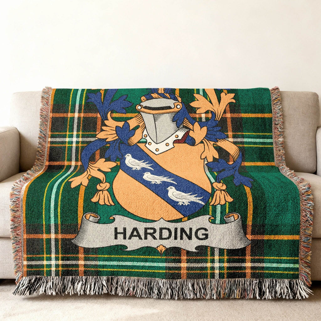 Harding family crest on a green plaid woven throw blanket.