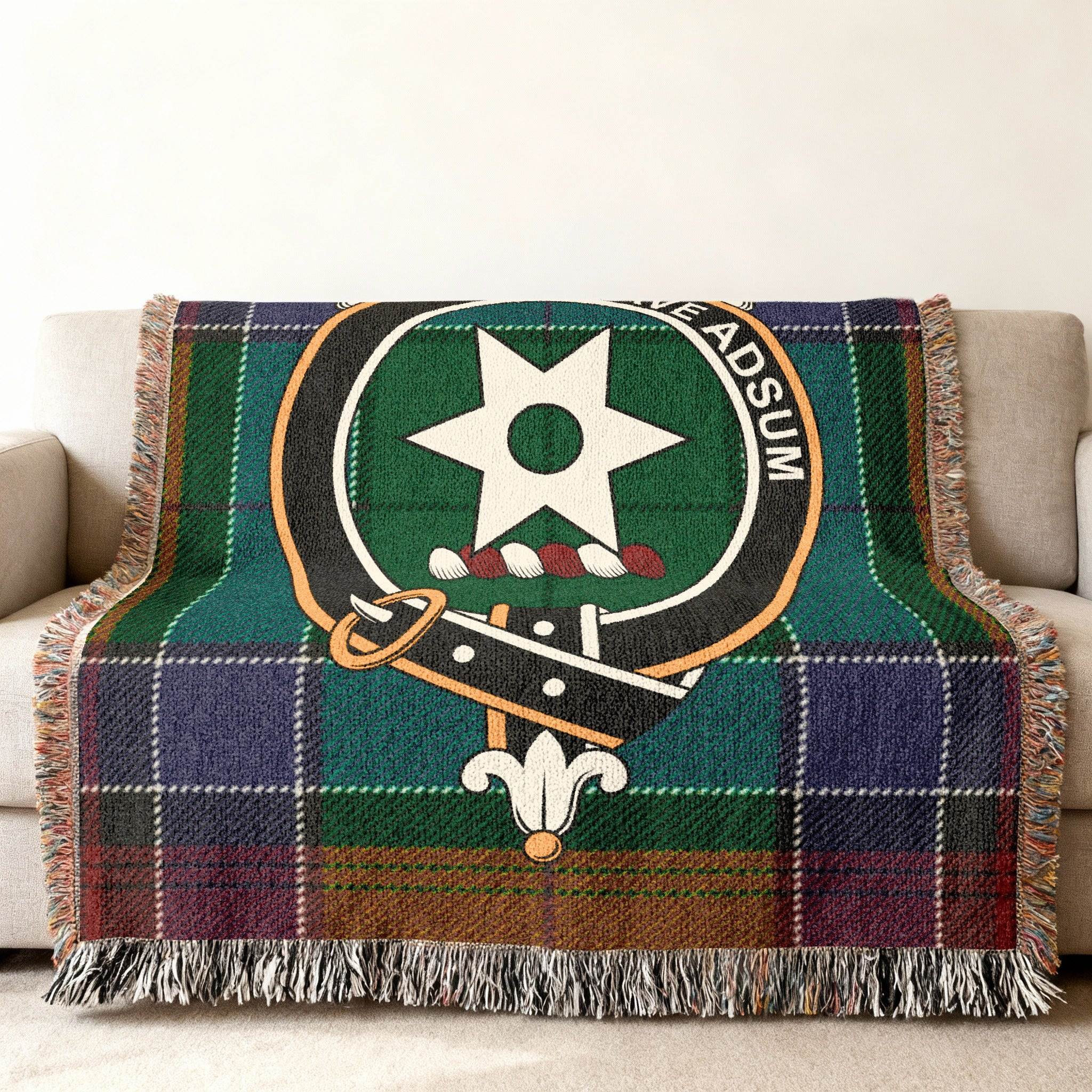 Clan Jardine woven blanket — 80x60 inch full size, Jardine crest and tartan on sofa display