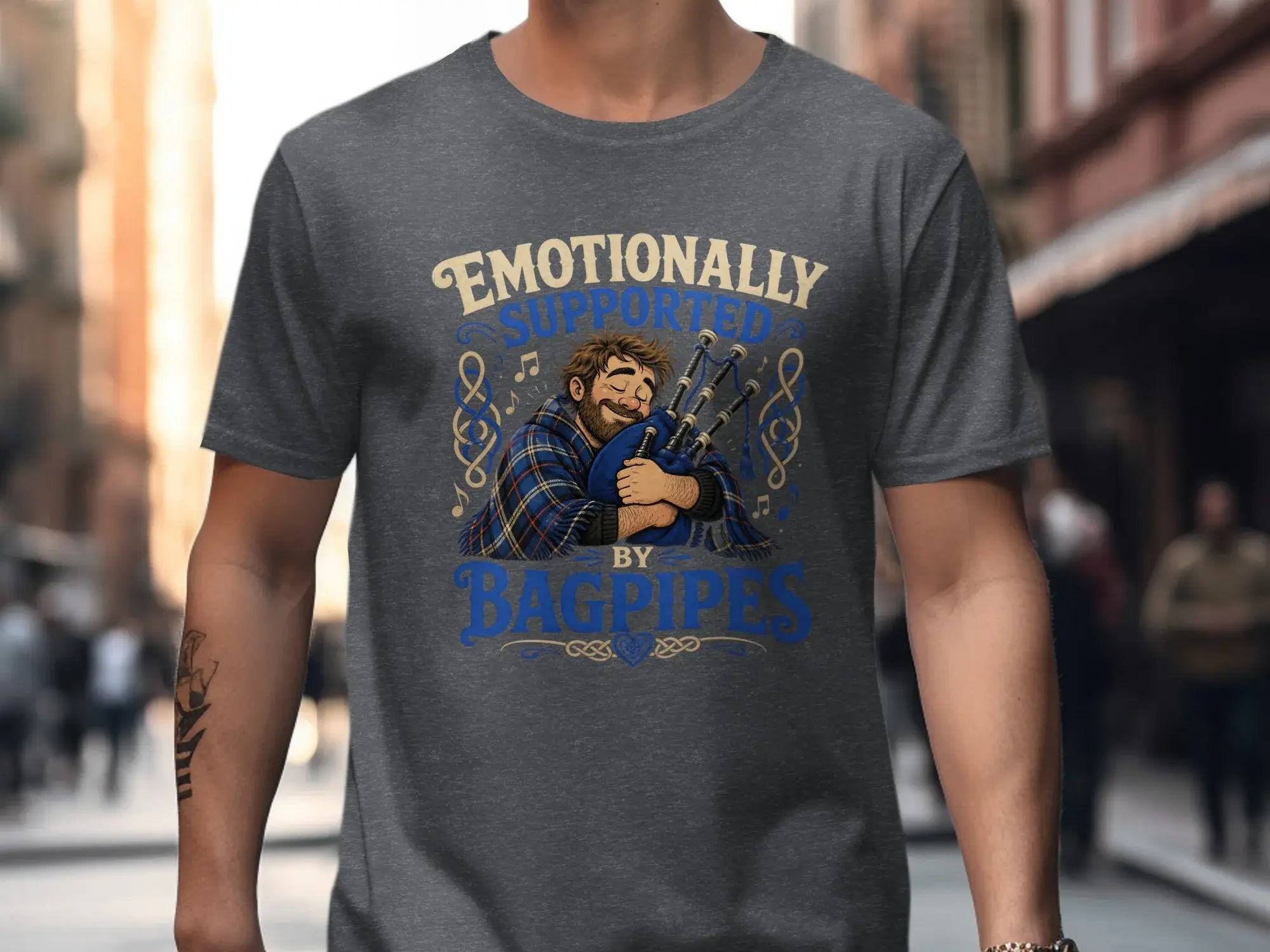 Man wearing t-shirt with "Emotionally Supported by Bagpipes" text and illustration.