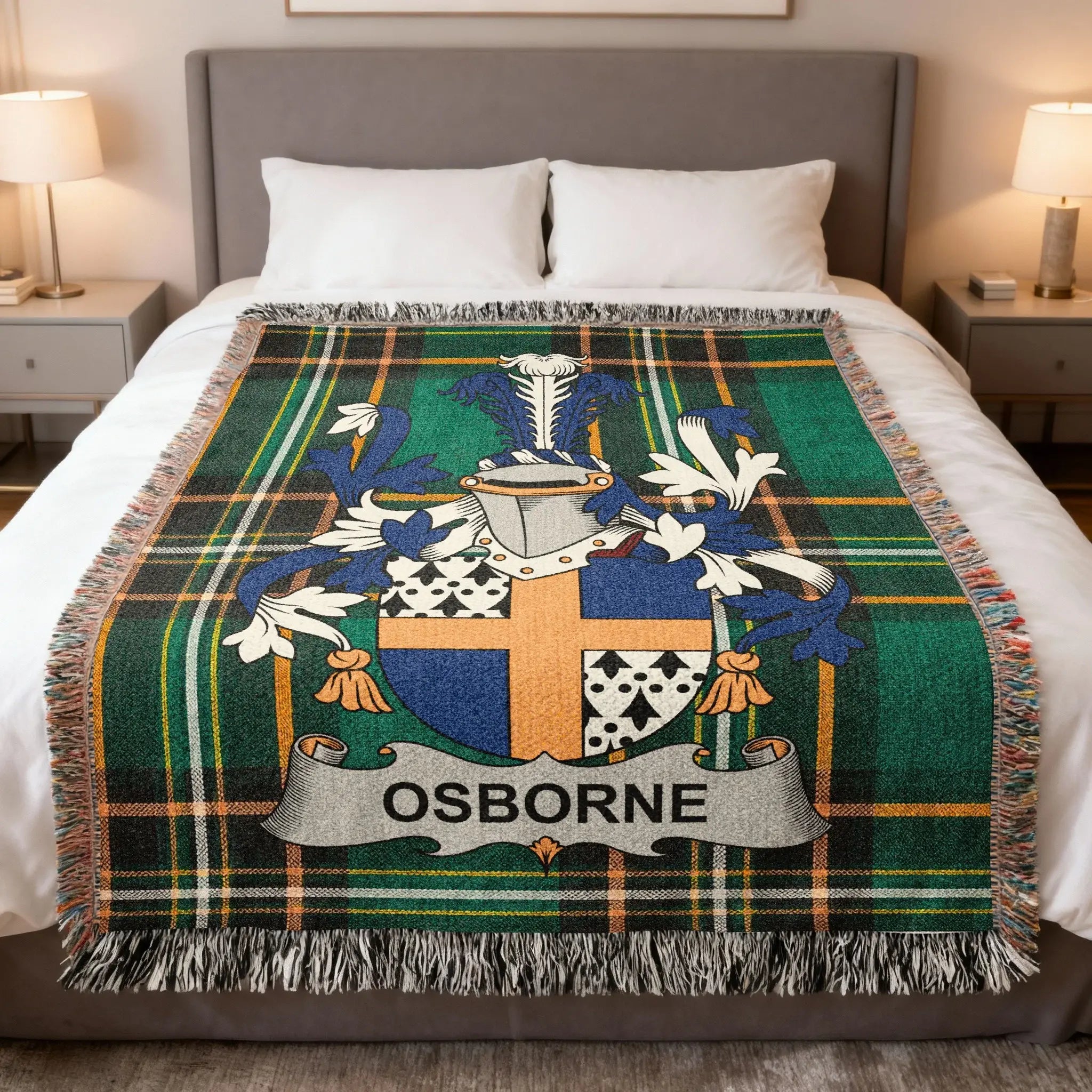 Osborne family crest on a green plaid woven throw blanket on a bed.