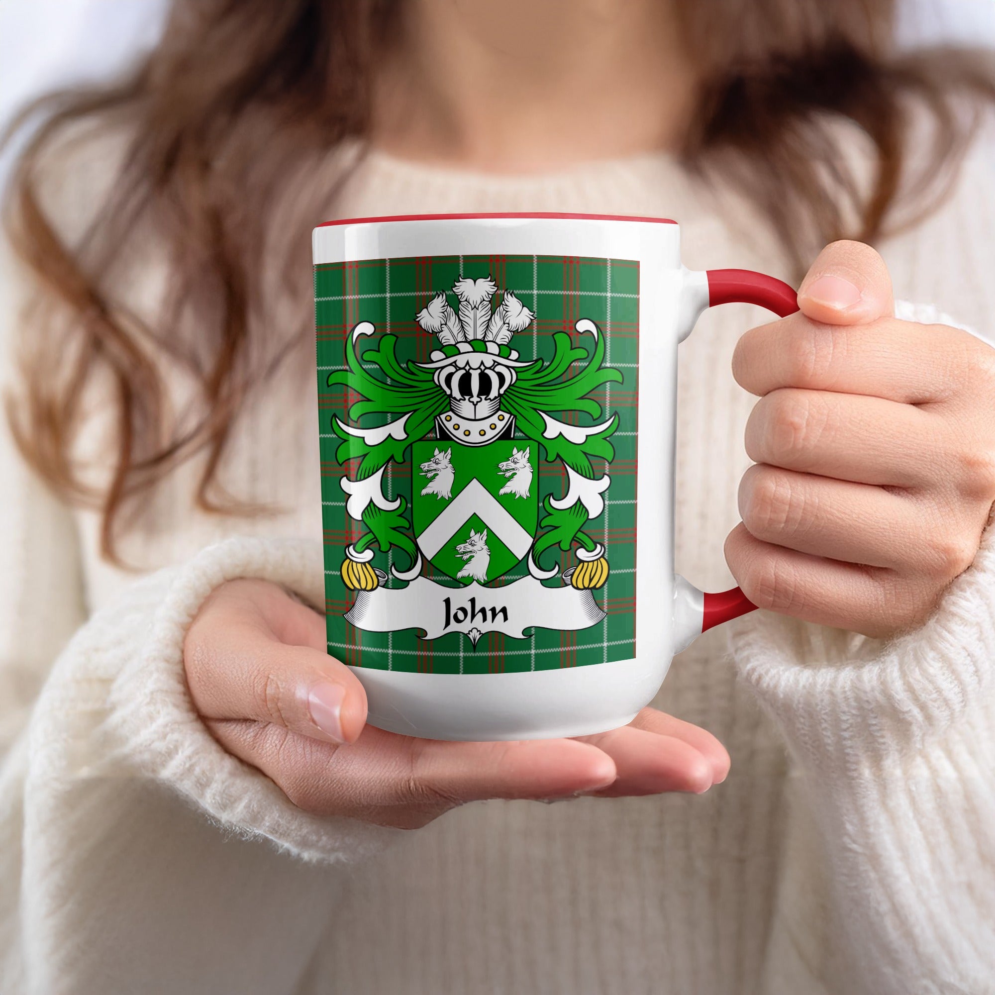 White mug with red trim featuring a family crest and the name "John" on a tartan background.