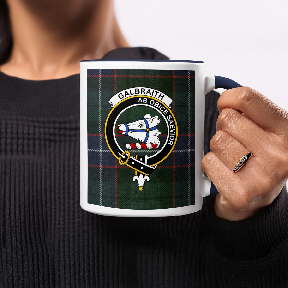 Close-up lifestyle view of Galbraith Scottish clan crest artwork on a navy 11 oz accent mug with a tartan background