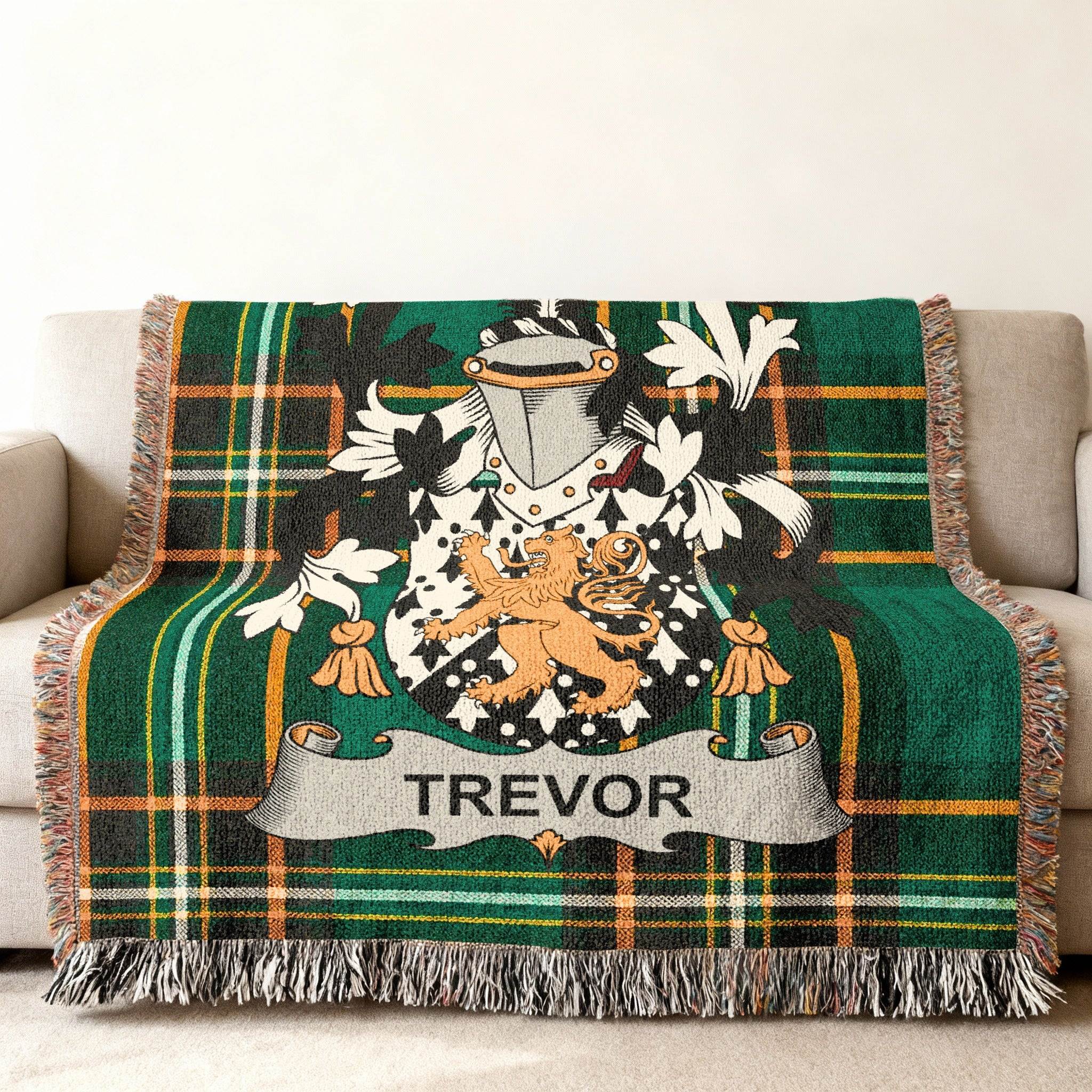 Tartan throw blanket with Trevor family crest on a sofa.