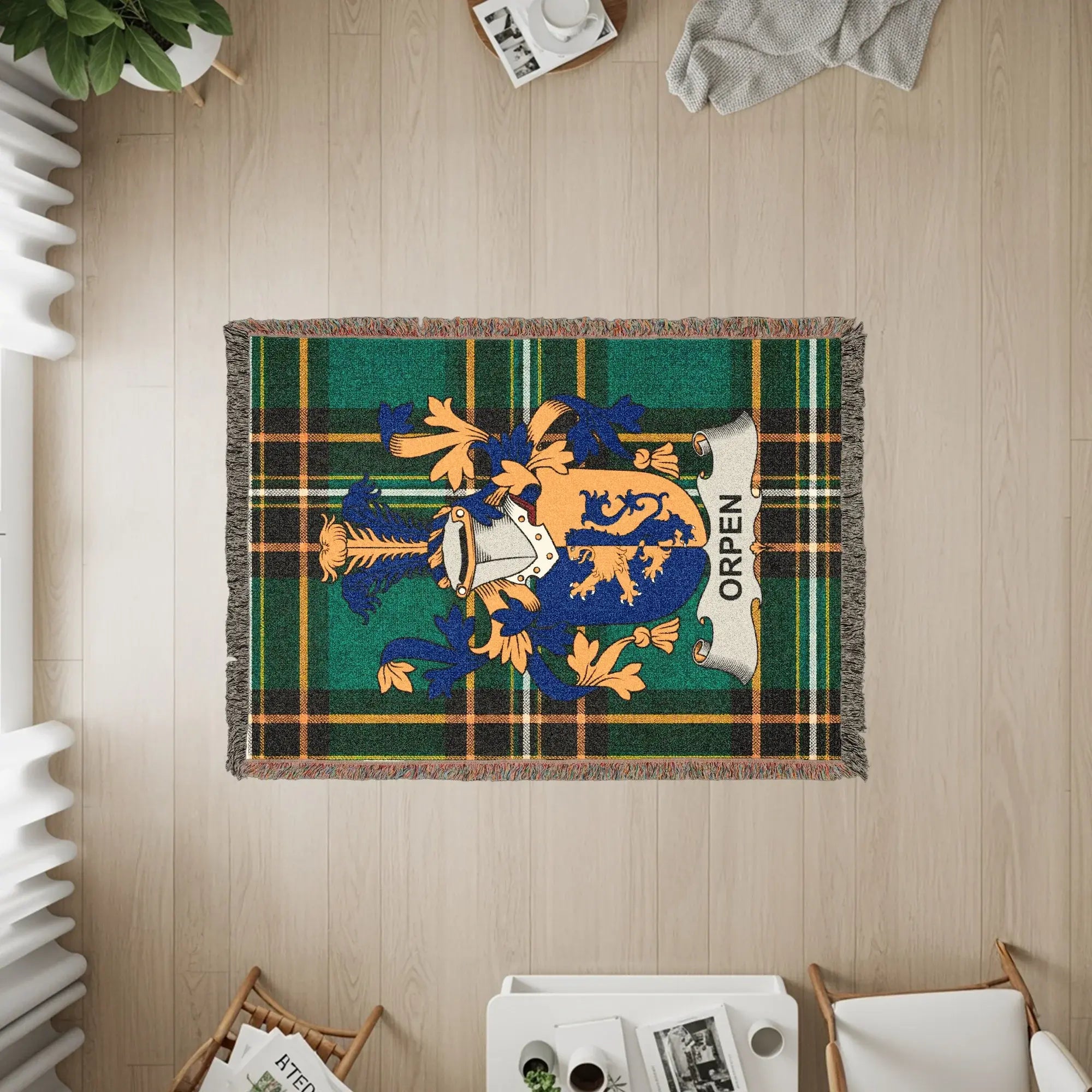 Woven blanket with the Orpen family crest and tartan pattern.