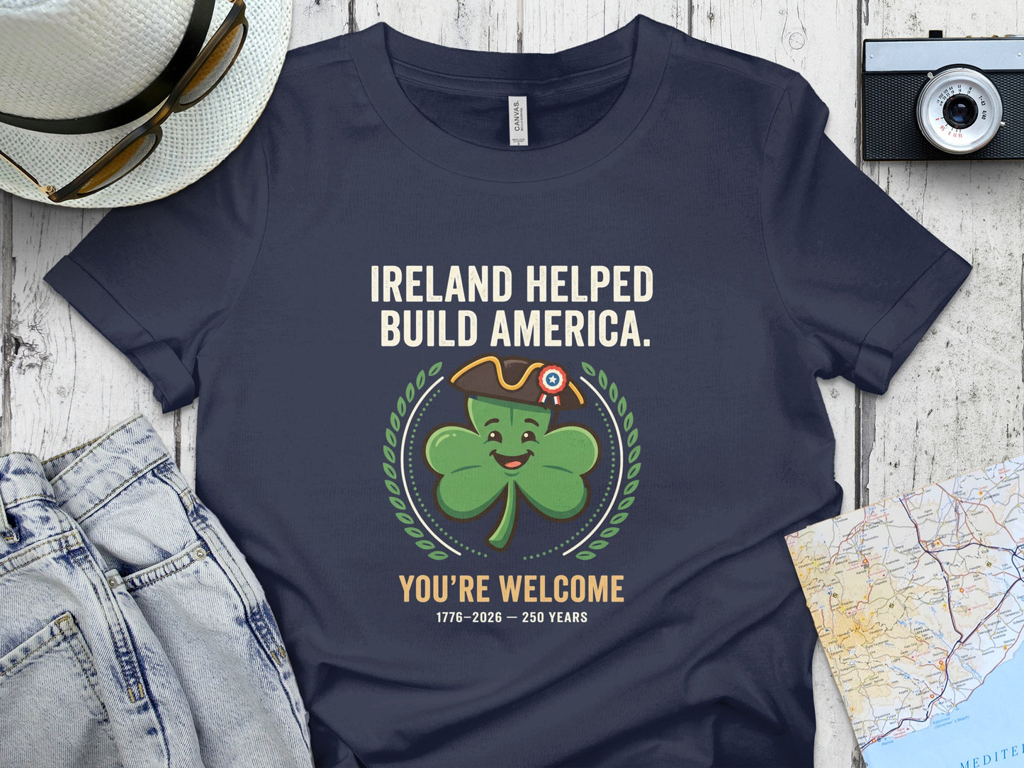 Navy t-shirt with "Ireland Helped Build America" and shamrock graphic.