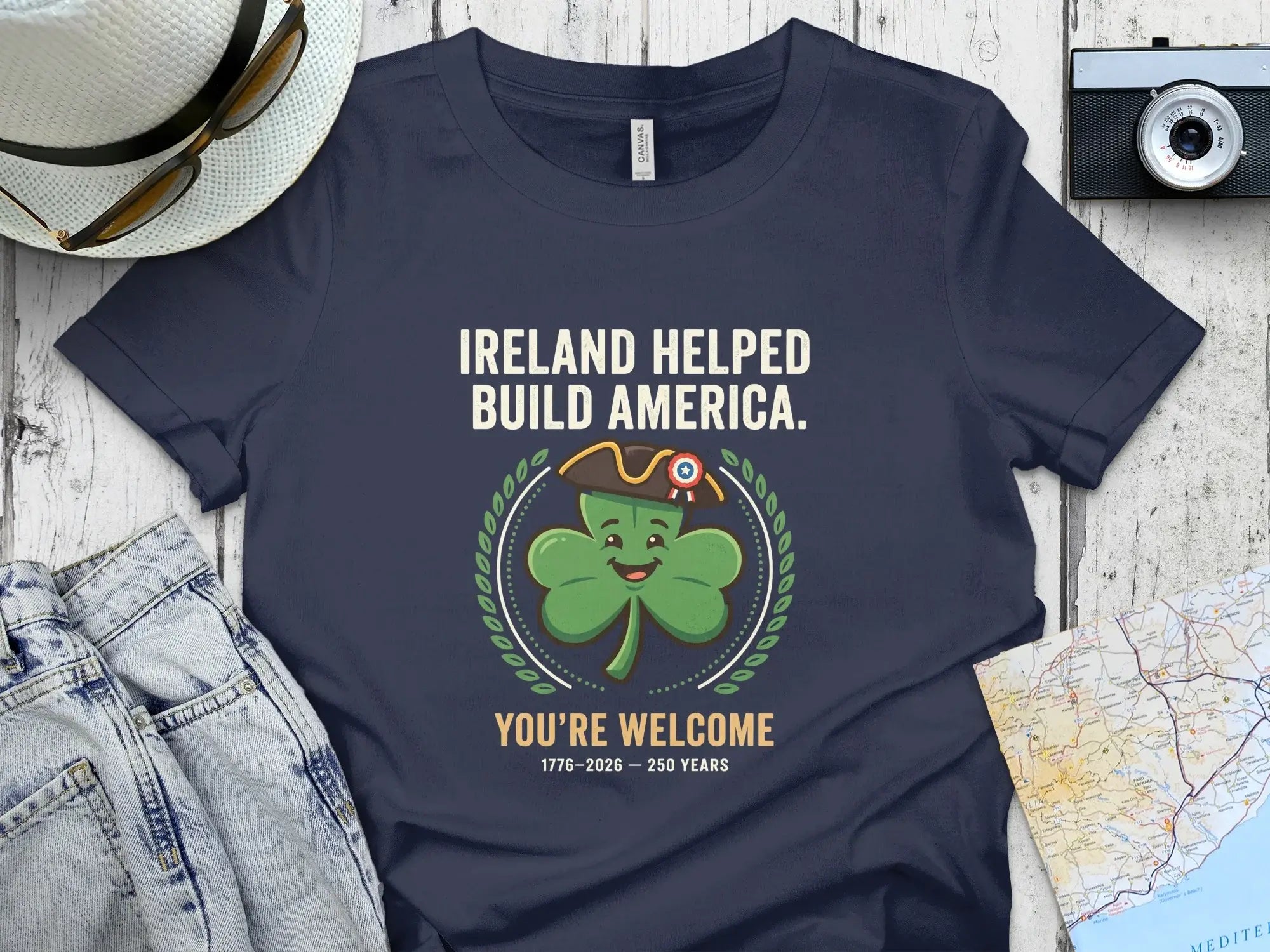 Navy t-shirt with "Ireland Helped Build America" and shamrock graphic.