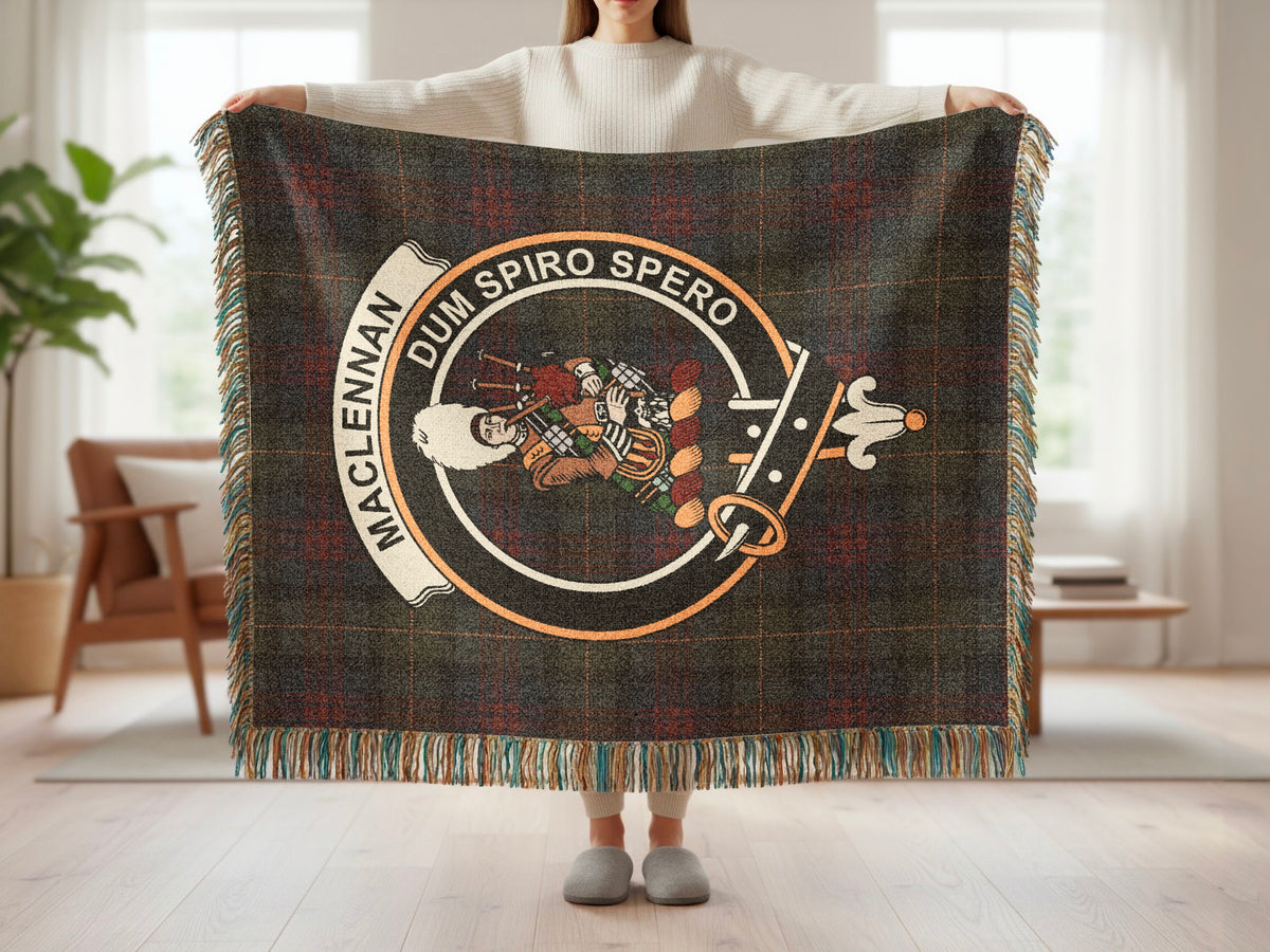Person holding the MacLennan woven blanket to show the full design, tartan background and fringe