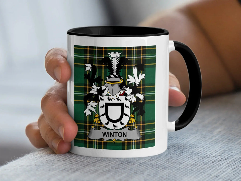 White mug with black rim displaying a green tartan pattern and a coat of arms with "Winton" text.