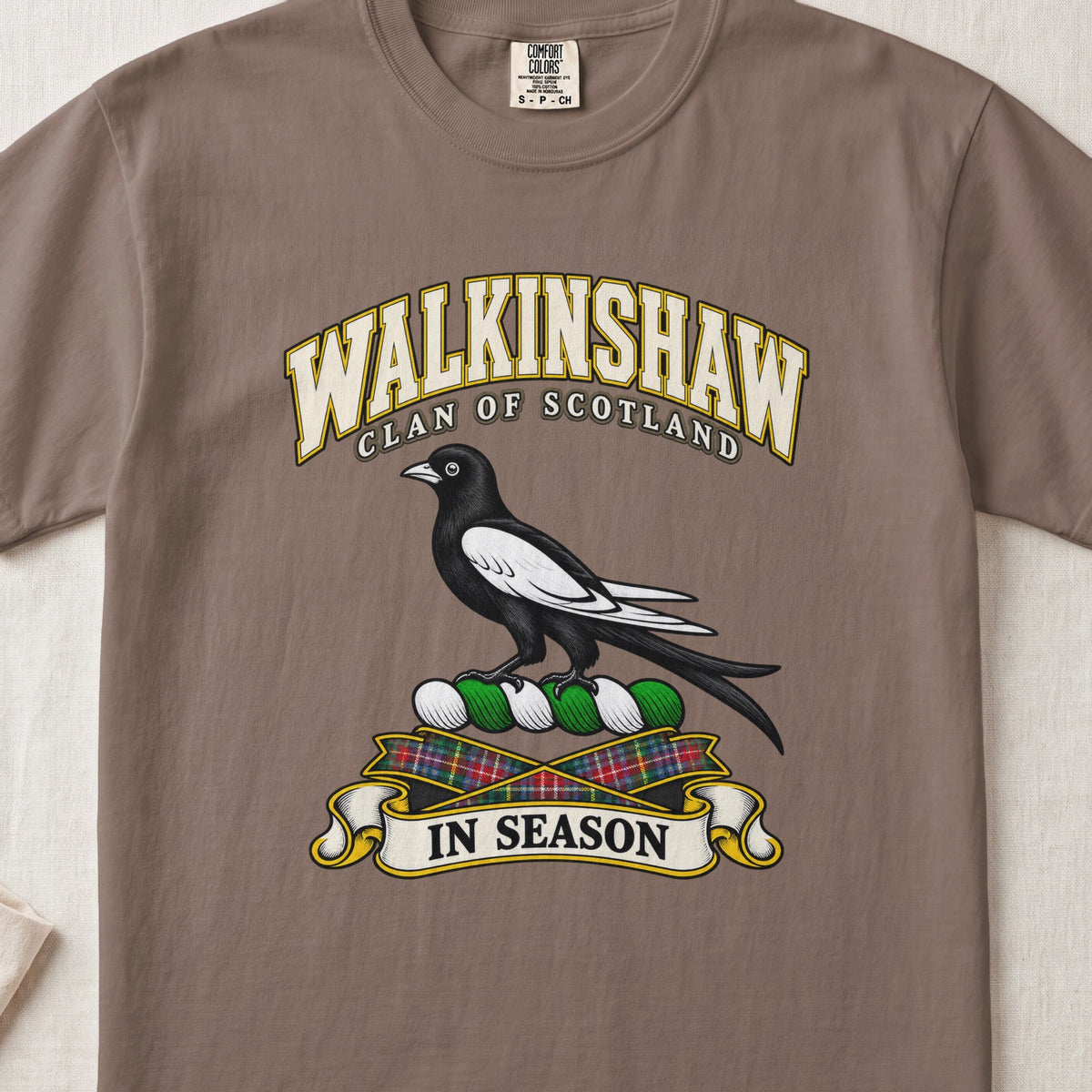 Walkinshaw Scottish clan T-shirt in Espresso, front view with a black and white magpie and motto design.