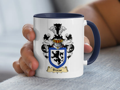 White mug with navy blue handle featuring the Brocas family crest.