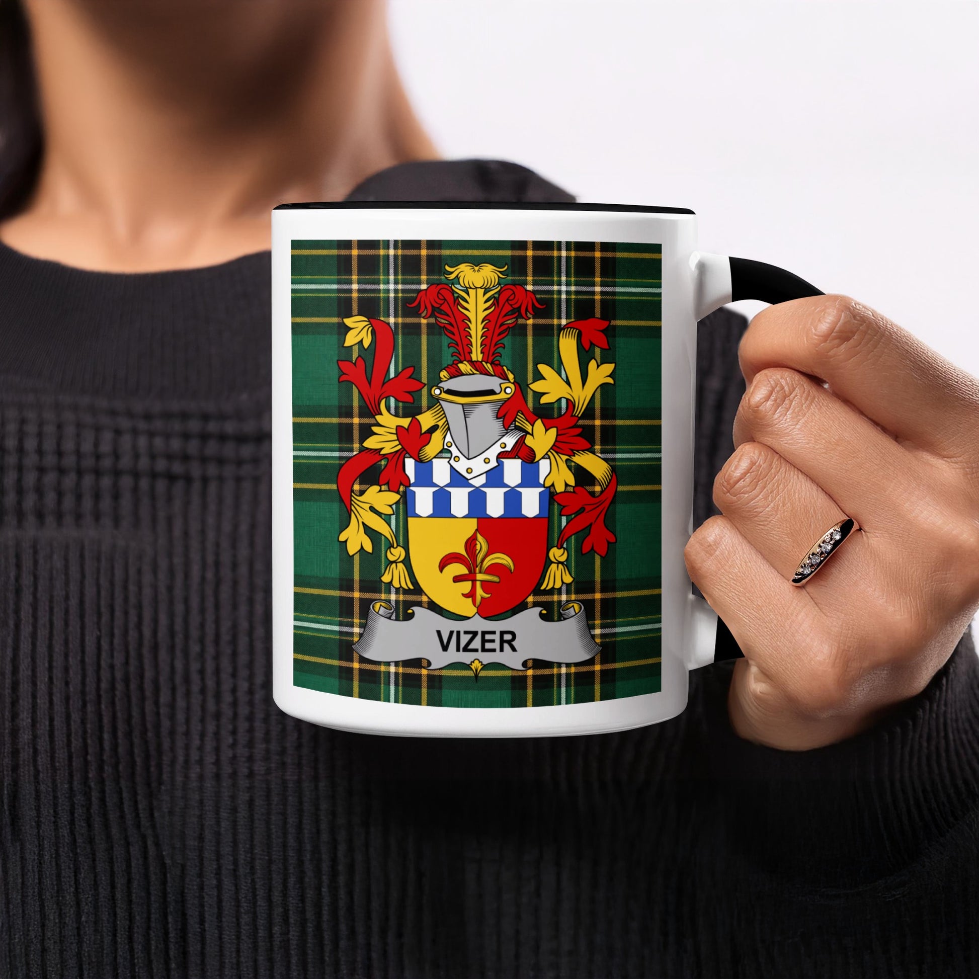 Mug with the Vizer coat of arms on a green plaid background.