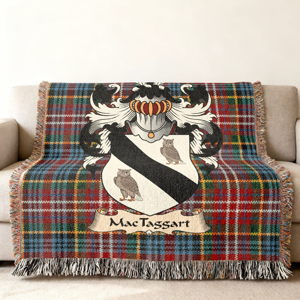 MacTaggart family crest emblem on a Caledonia tartan woven blanket