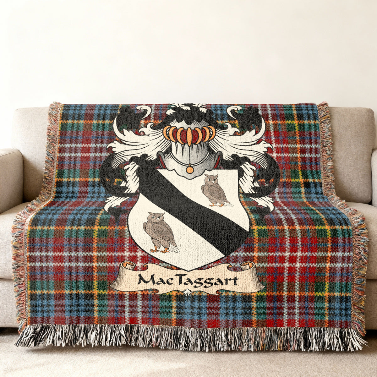 MacTaggart family crest emblem on a Caledonia tartan woven blanket