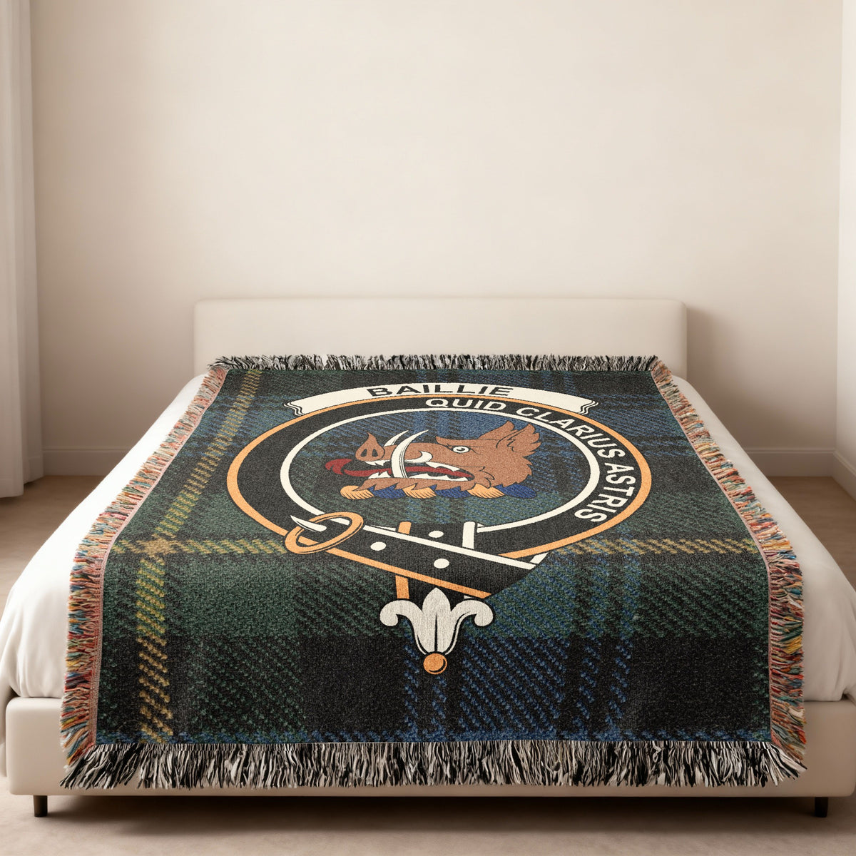 Baillie Scottish woven blanket spread across a bed, showing the full crest design and tartan background