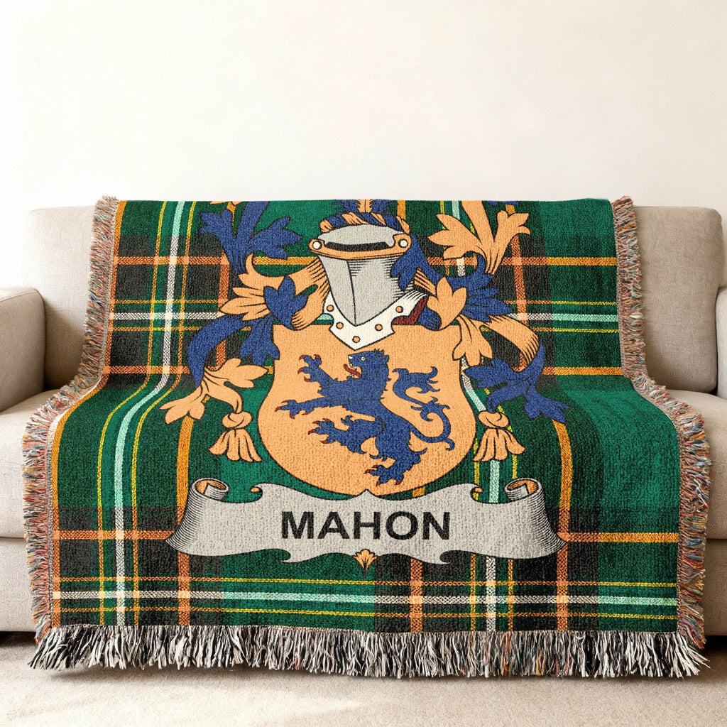 Green tartan throw blanket with MAHON family crest in the center.