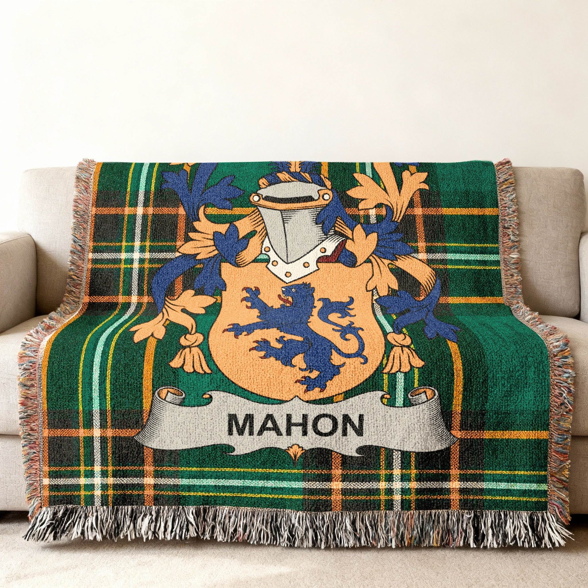 Green tartan throw blanket with MAHON family crest in the center.