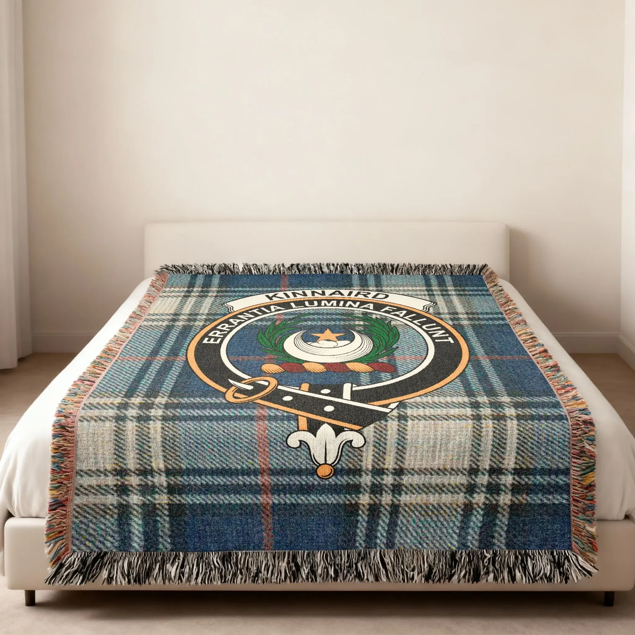 Clan Kinnaird tartan woven blanket — folded view showing fringe detail and Errantia Lumina Fallunt crest
