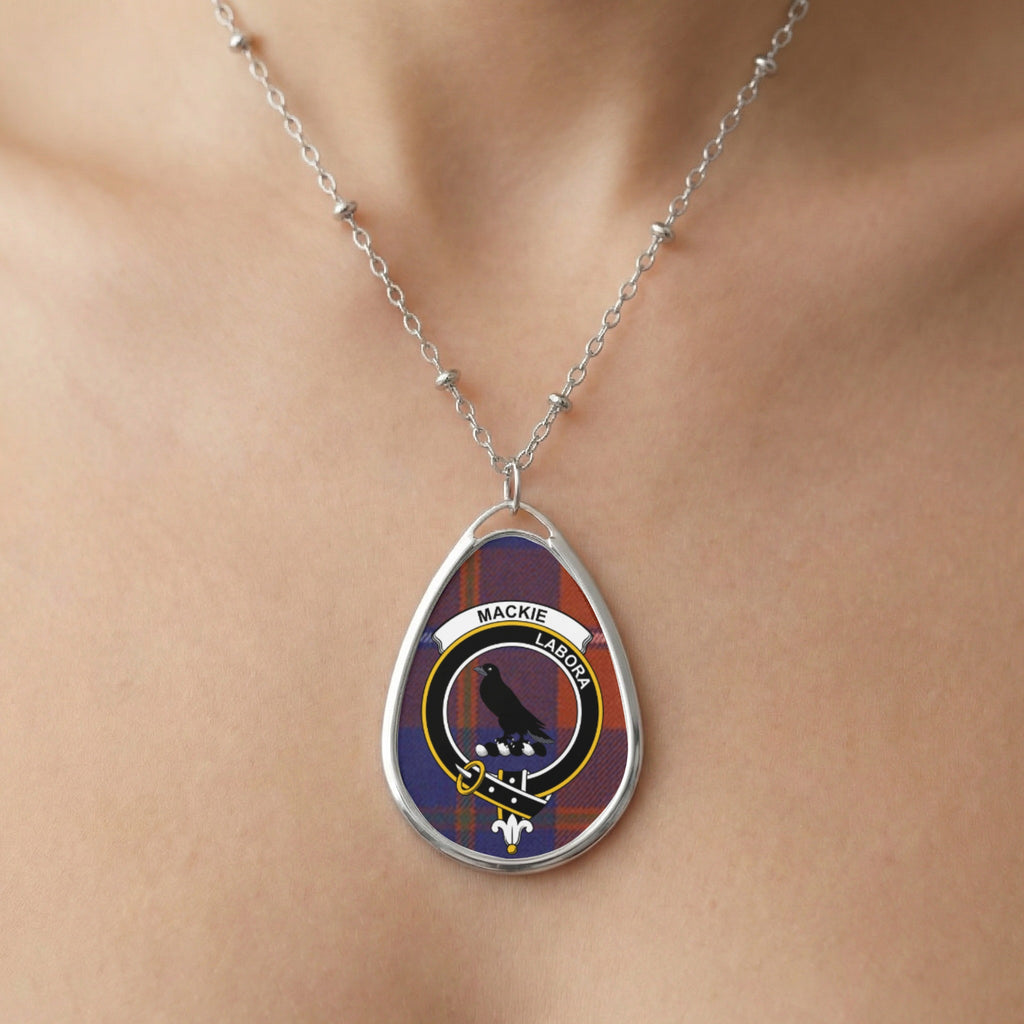 Teardrop pendant with Mackie tartan and blackbird crest on silver chain.