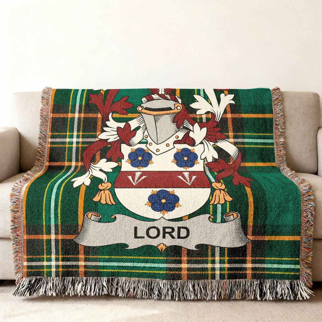 Green tartan blanket featuring the Lord family crest with tassels.
