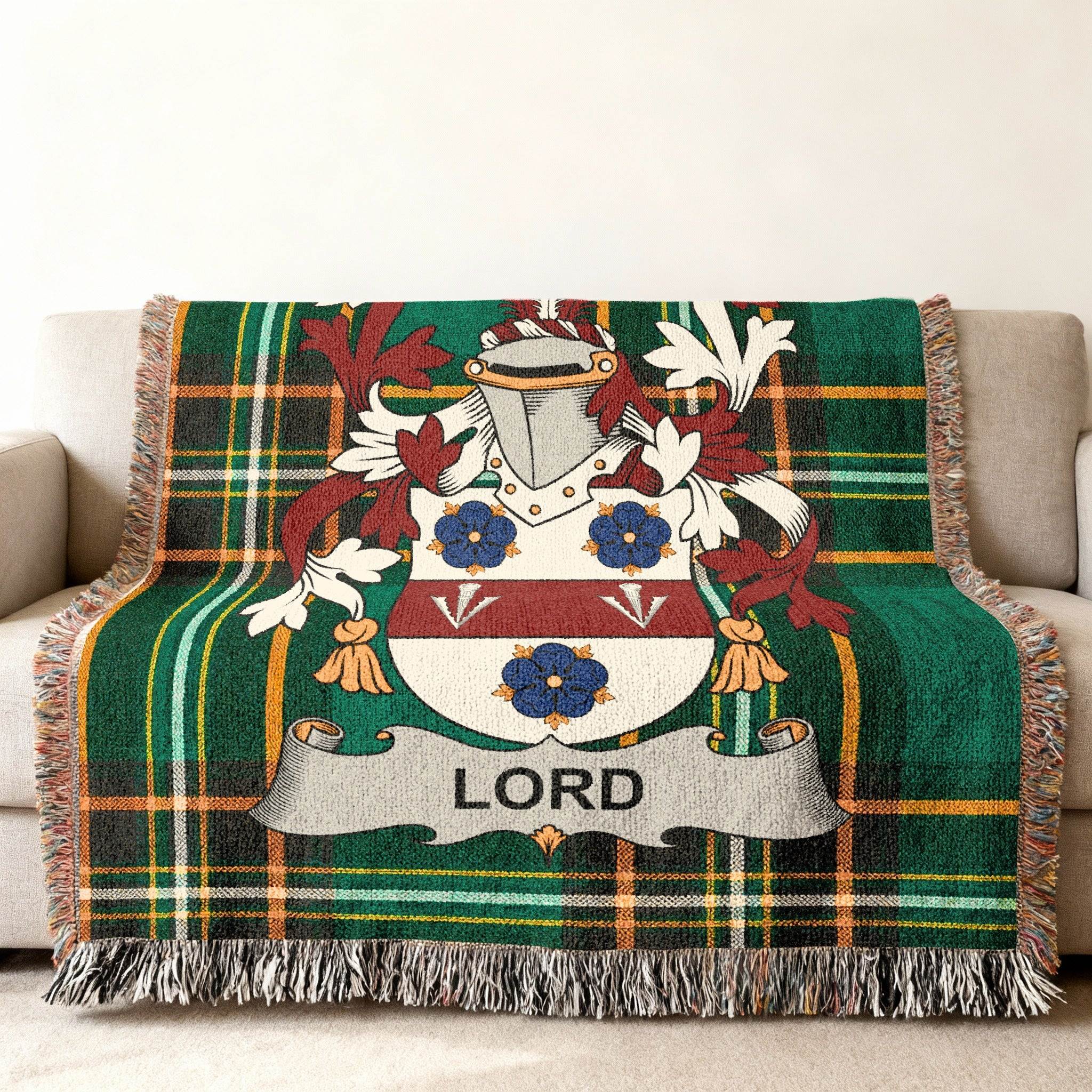 Green tartan blanket featuring the Lord family crest with tassels.