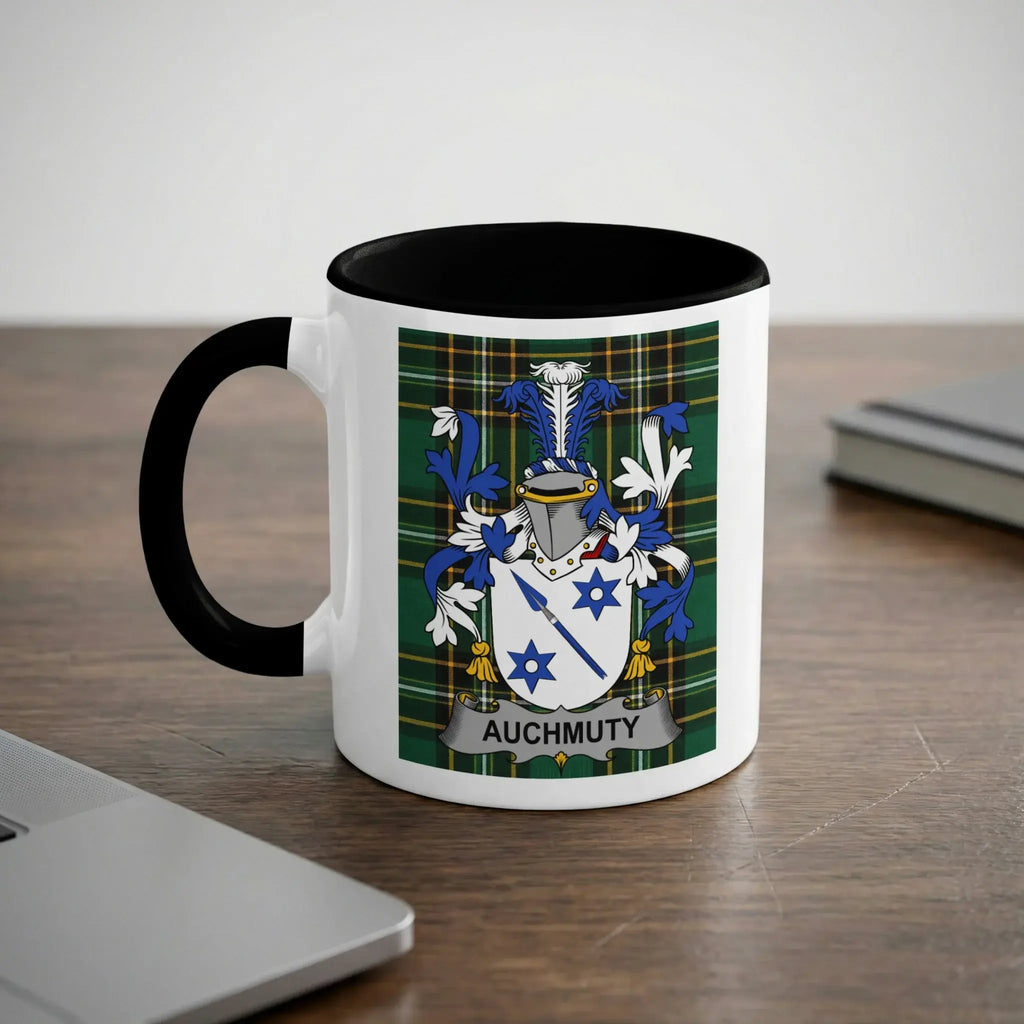 White mug with black handle displaying the Auchmuty family crest on a plaid background.