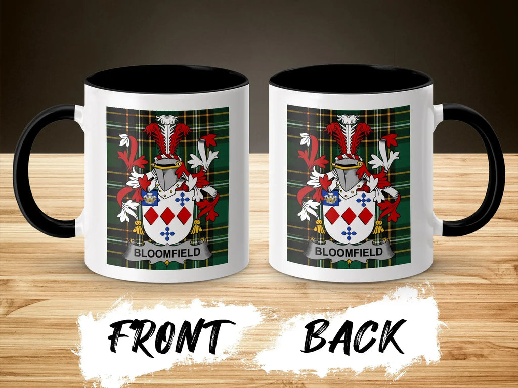 Two mugs displaying a Bloomfield family crest on a wooden surface.