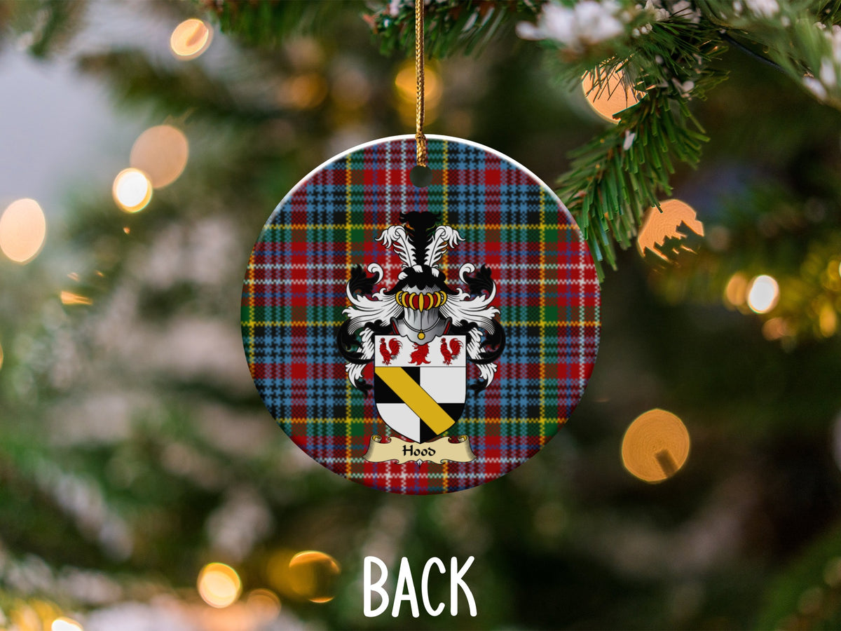 Hood ceramic ornament detail showing a double-sided family shield on a Caledonia tartan background