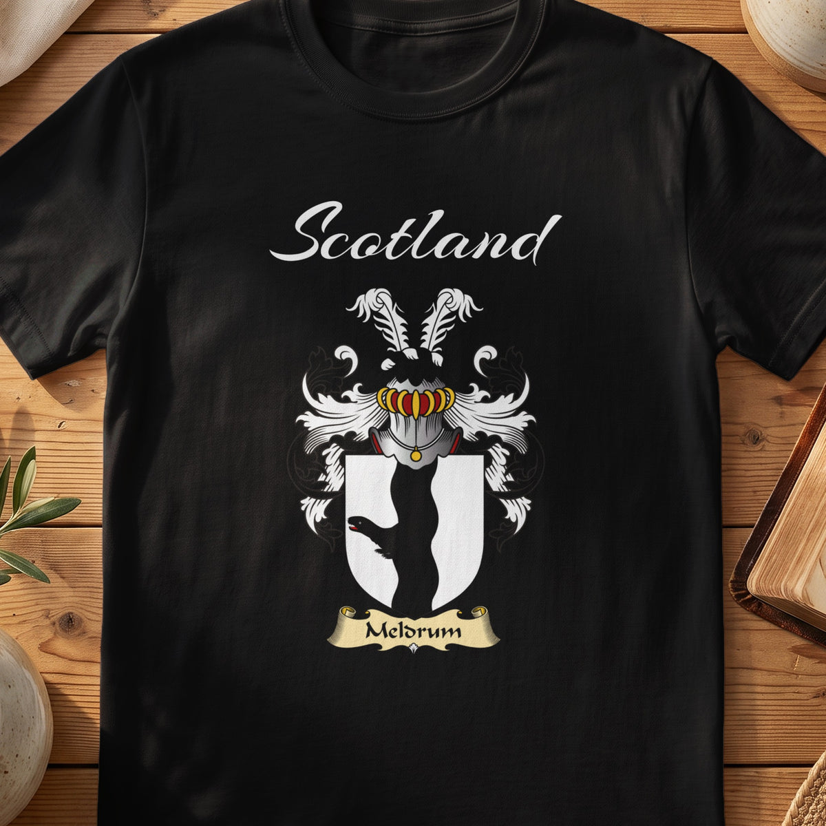 Black Meldrum Scottish T-shirt featuring a black animal-leg silhouette on a white shield