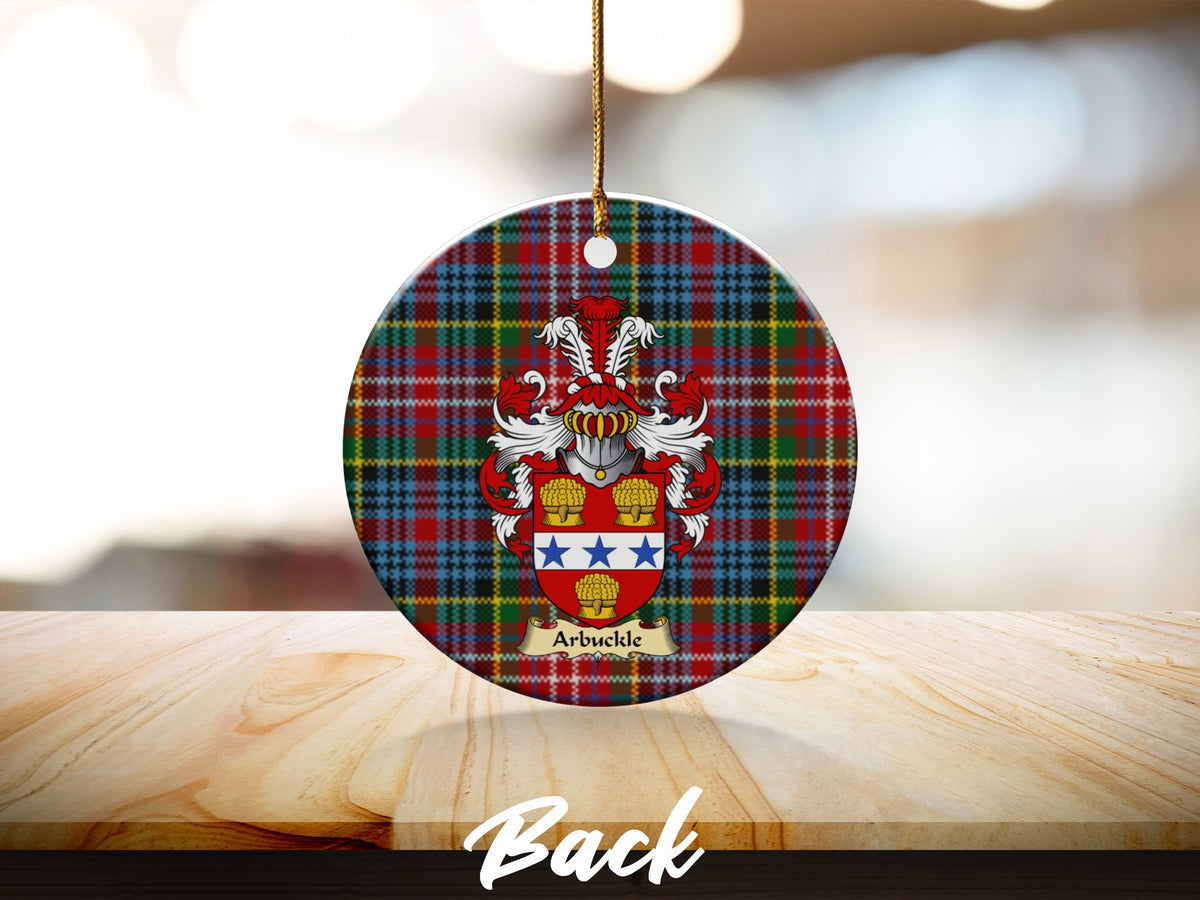 Round Arbuckle Scottish clan ornament with family crest on a Caledonia tartan background