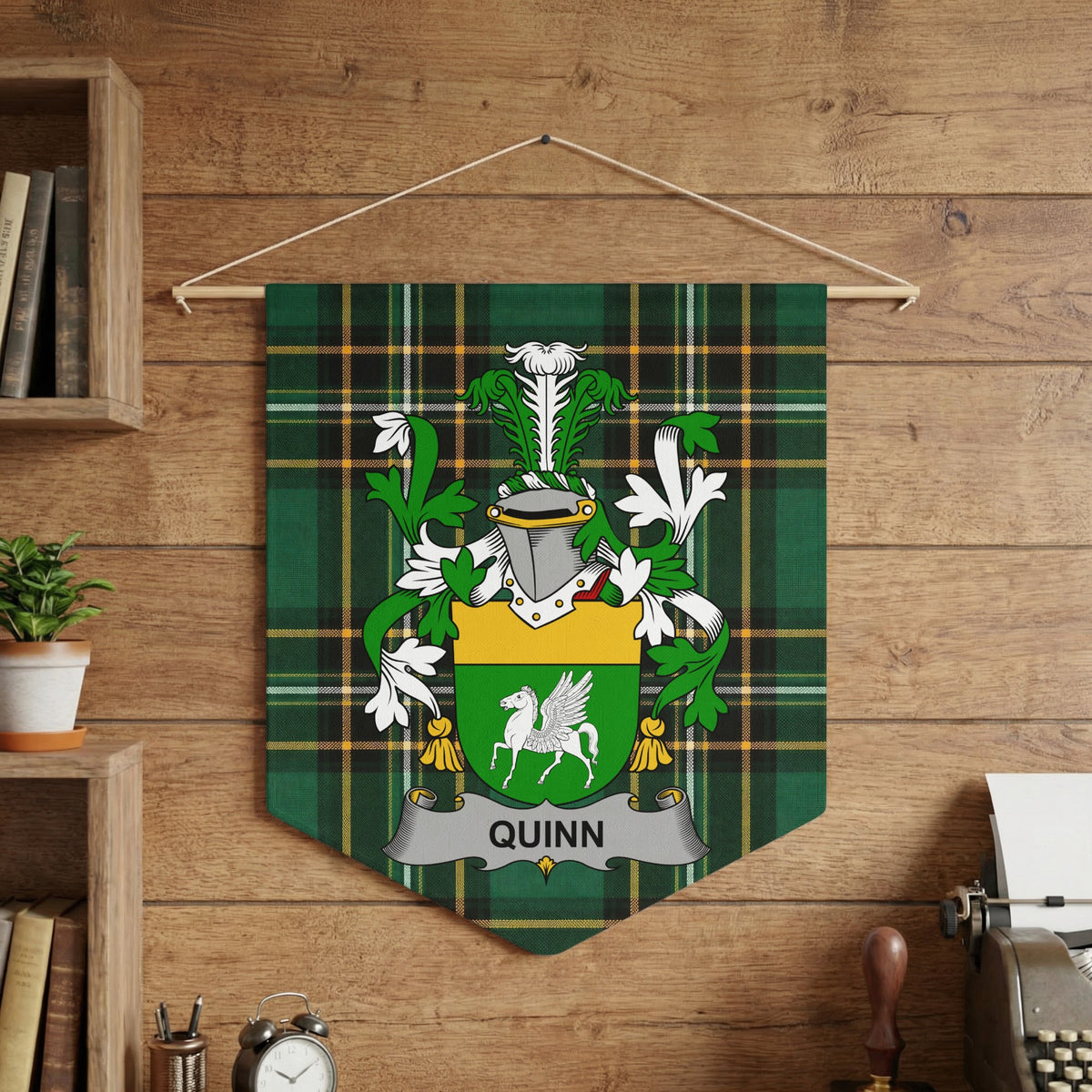 Quinn family crest on green plaid banner, hanging on a wooden wall.