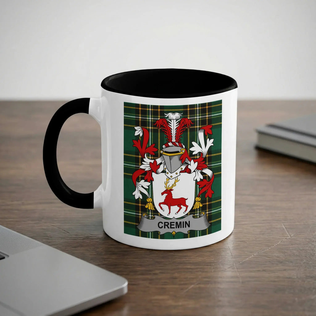 White mug with black rim featuring a coat of arms with the name "CREMIN".