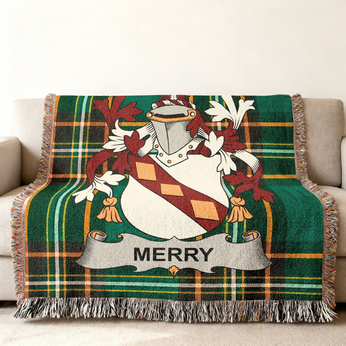 Green plaid throw blanket with Merry family crest draped over a sofa.