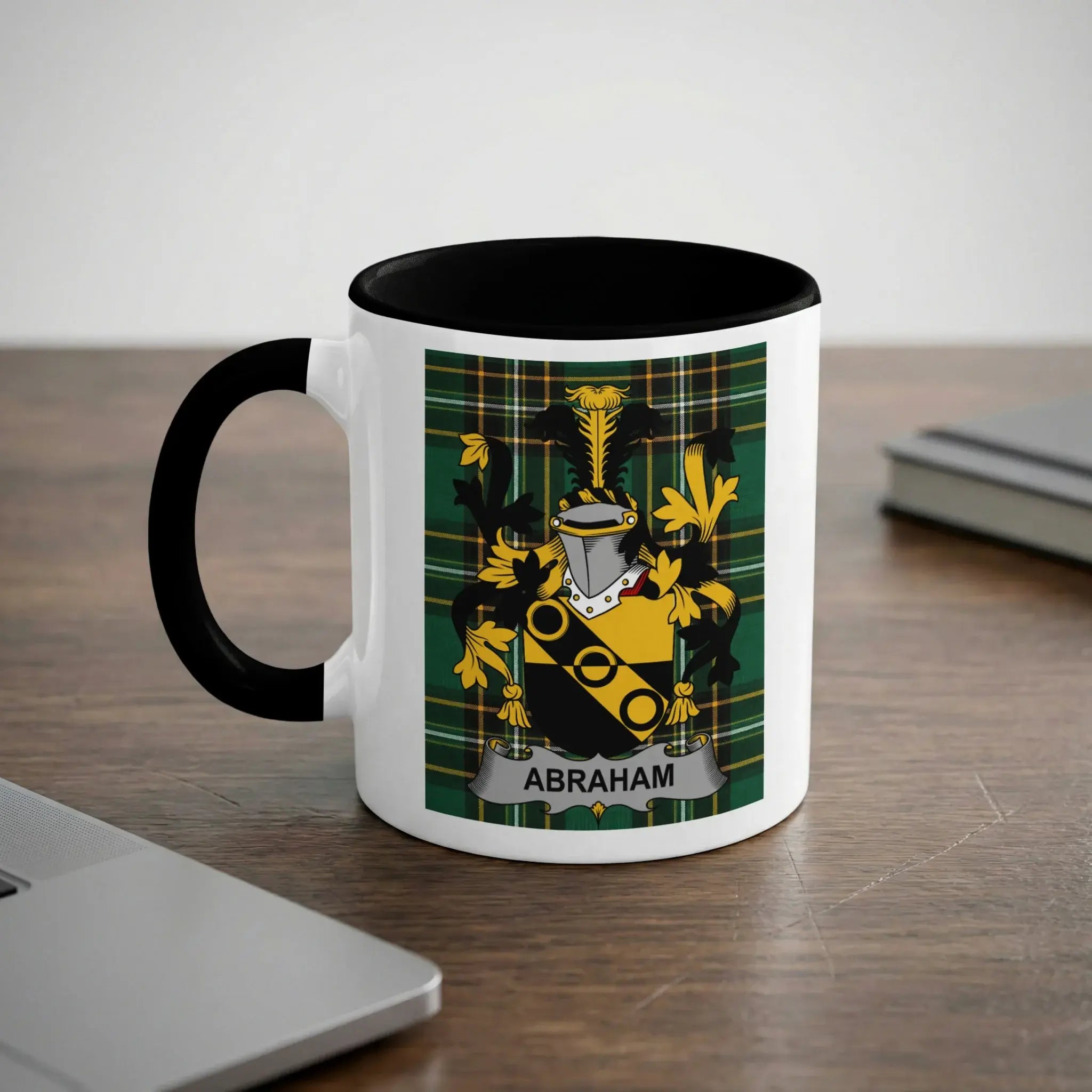 White mug with black handle displaying a coat of arms with the name Abraham.