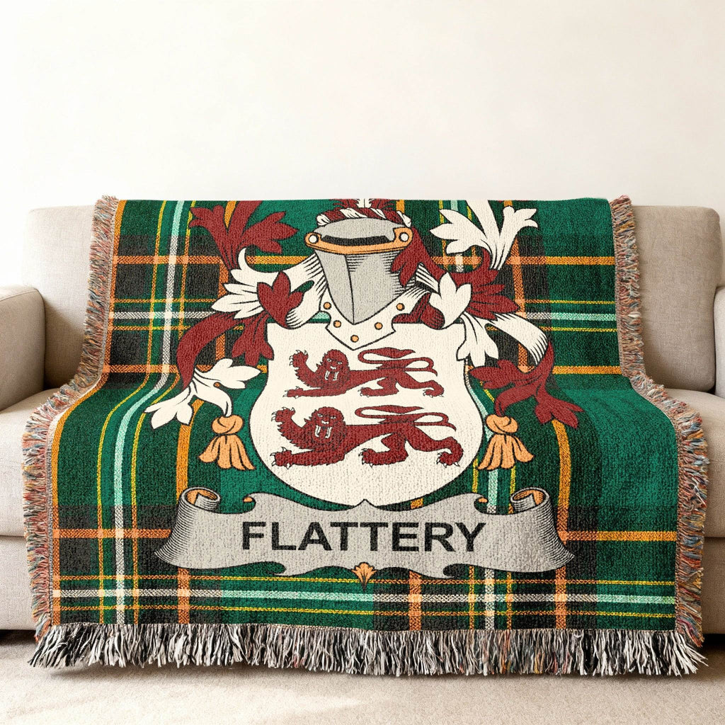 Green plaid throw blanket featuring the Flattery family crest with lions and shield.