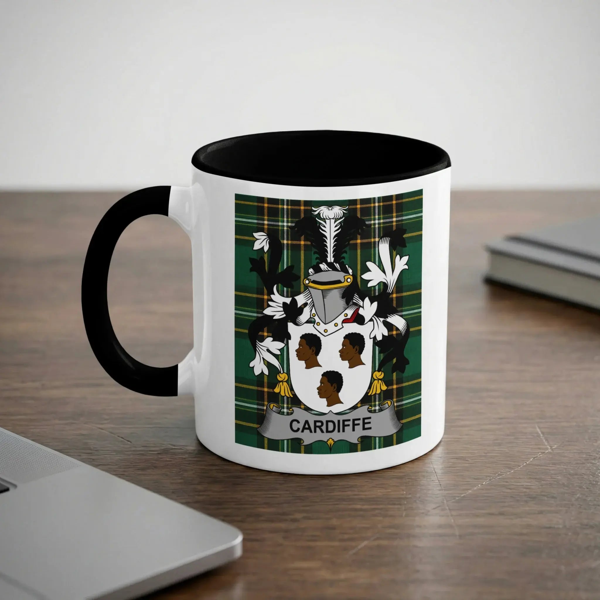 White mug with black handle and rim, featuring the Cardiff family crest.