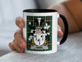 White mug with black rim featuring a green tartan crest with "GIBBS" text.