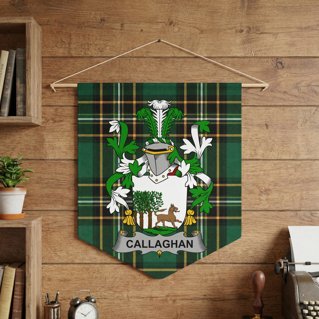 Callaghan crest on green tartan pennant hanging on wood-paneled wall.