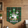 Callaghan crest on green tartan pennant hanging on wood-paneled wall.