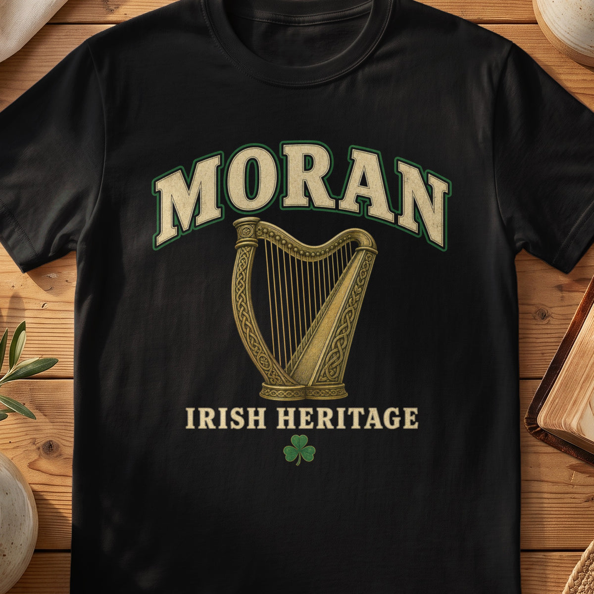 Moran Irish harp T-shirt in Black, with cream surname lettering, a gold-toned harp, green shamrock and “Irish Heritage” text.