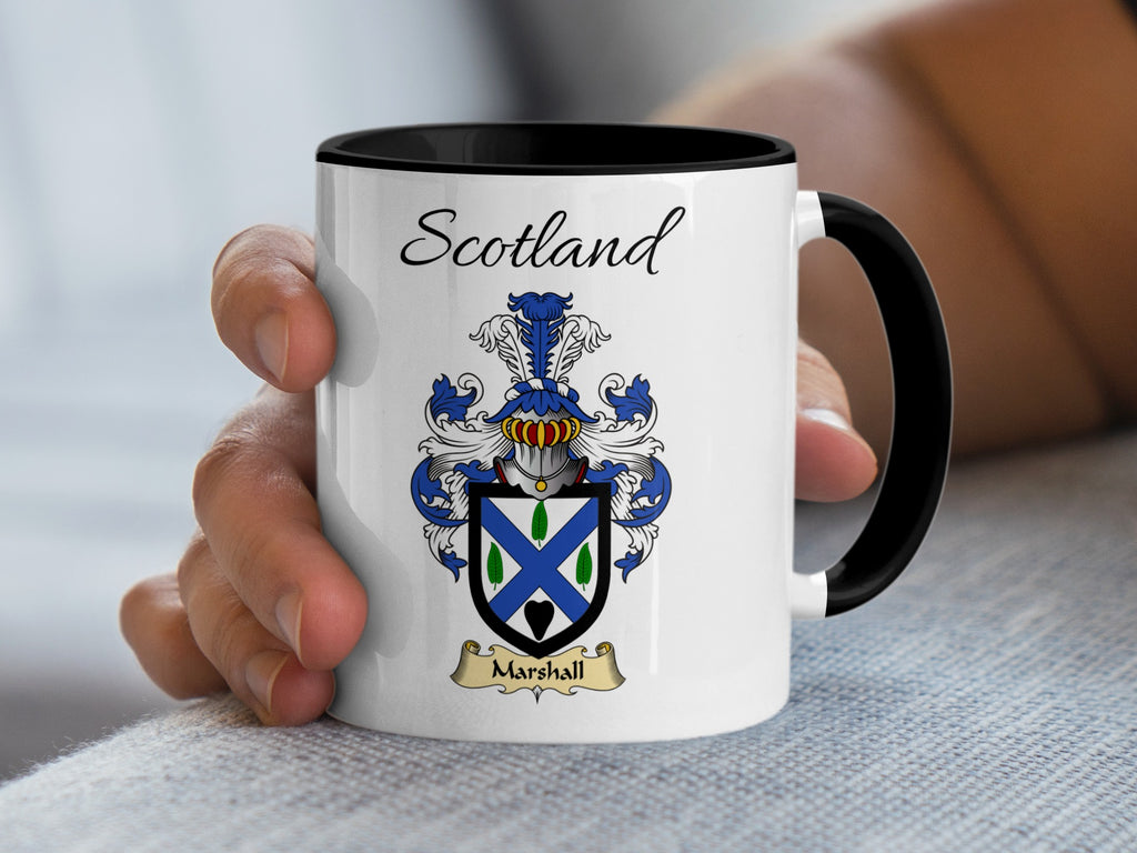 Marshall Scottish family shield on a white 11 oz mug with black handle and interior, shown held in hand