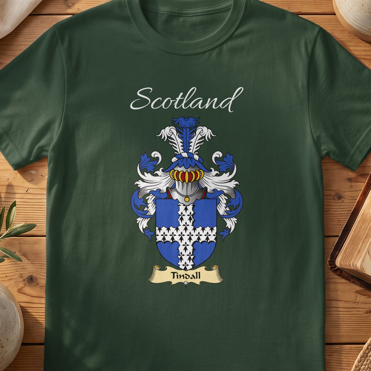 Forest Green Tindall Scottish T-shirt laid flat with coat of arms artwork and “Scotland” text.