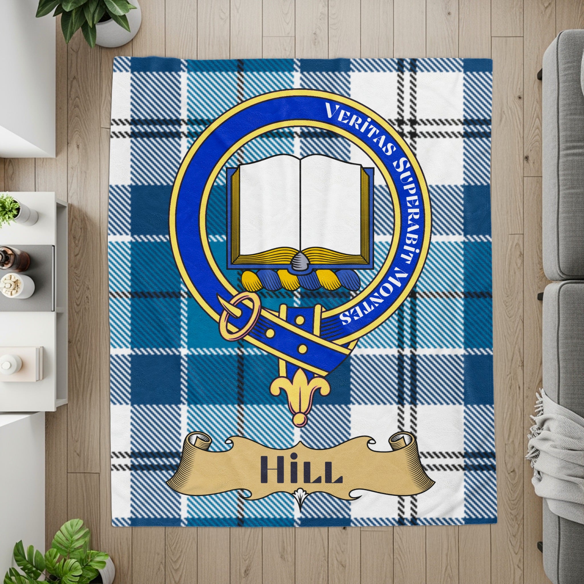 Hill crest with open book on blue tartan printed throw — flat lay